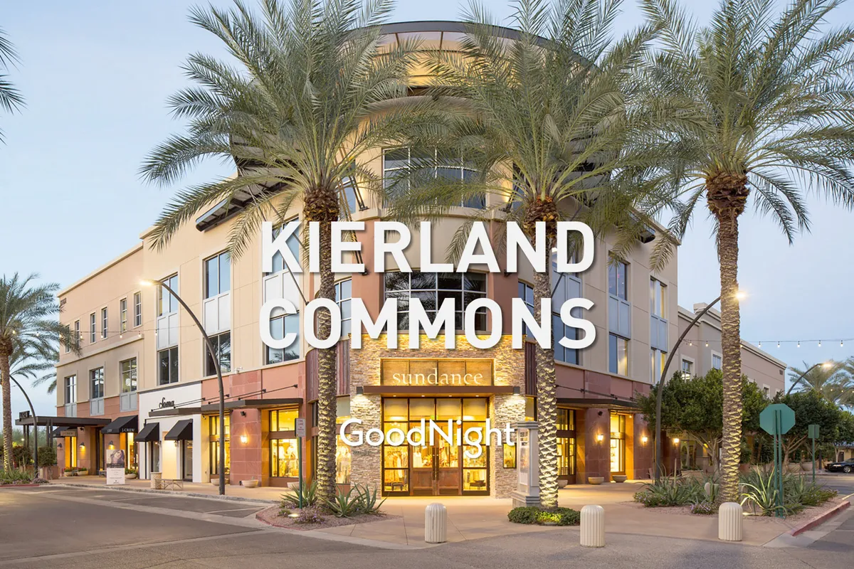 A vibrant shopping and dining district lined with palm trees and welcoming storefronts. The warm lighting and festive atmosphere invite visitors to explore, dine, and socialize, illustrating the appeal of nearby upscale amenities.